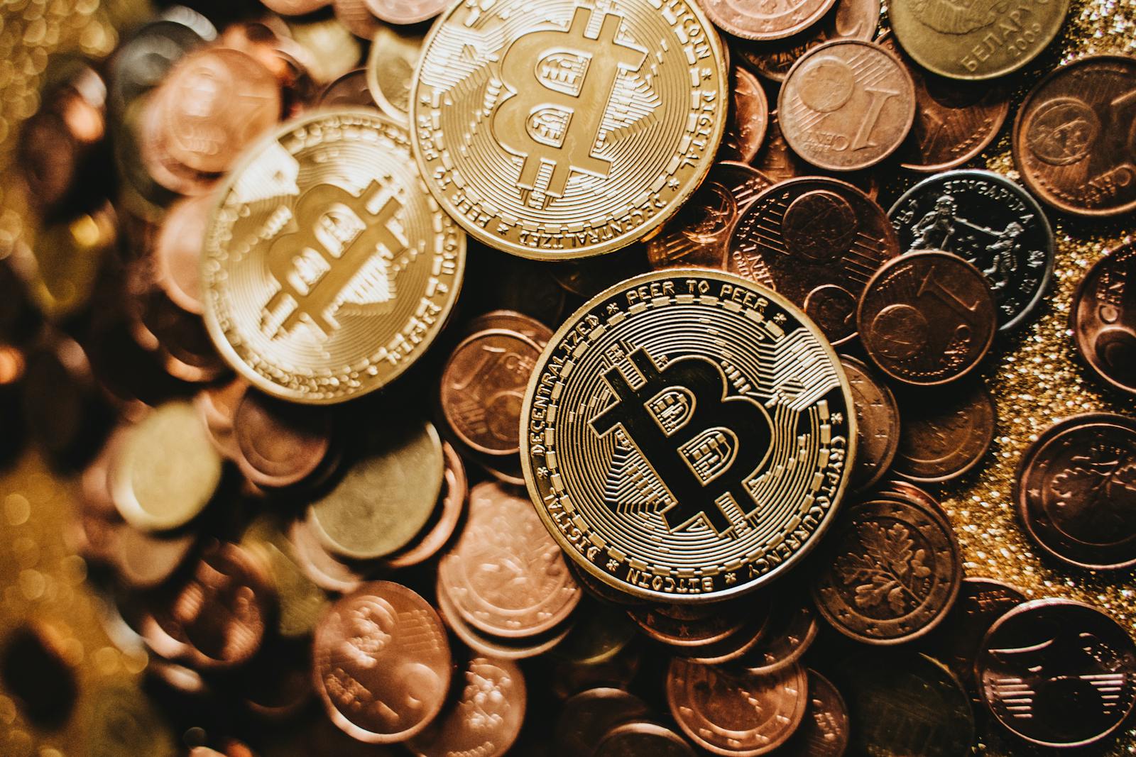 A detailed close-up of shiny bitcoins and assorted coins symbolizing digital currency and wealth.